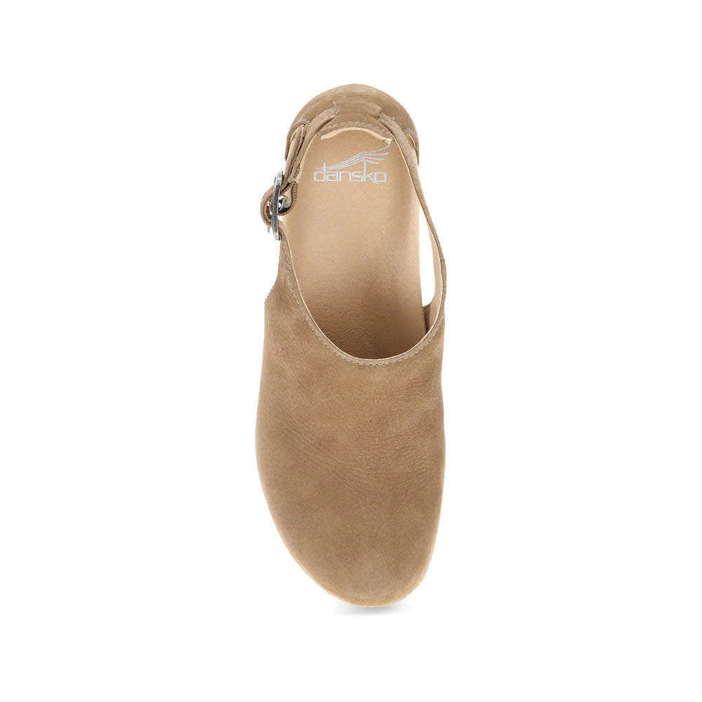 Top-down view of a single Dansko Sassy Morel clog in beige, highlighting its high-quality leather construction and a side strap with a buckle, along with its contoured arch support.