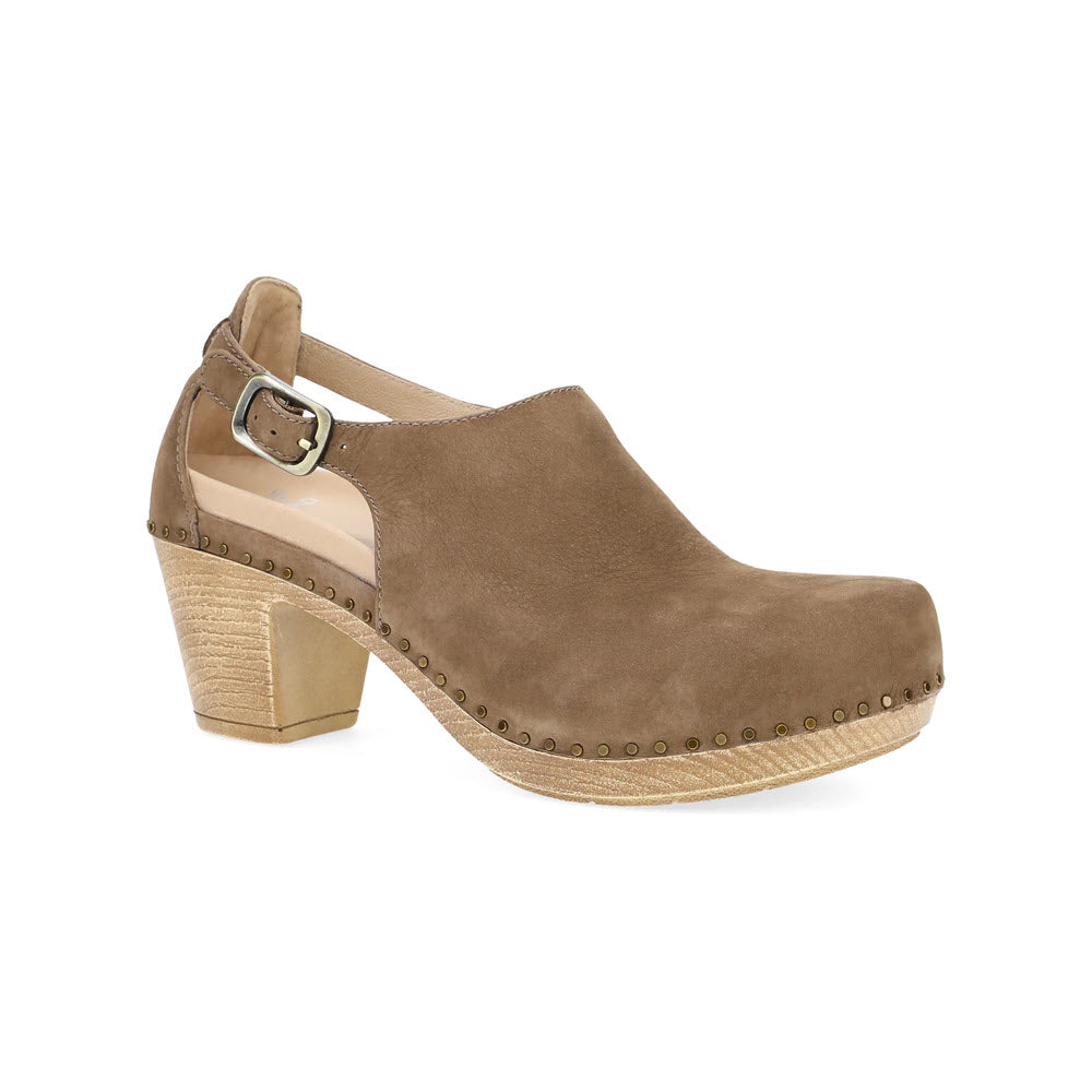 The DANSKO SASSY MOREL - WOMENS by Dansko is a tan suede clog with a wooden block heel, featuring an adjustable buckled strap and studded detailing around the sole. It also offers contoured arch support for all-day comfort.