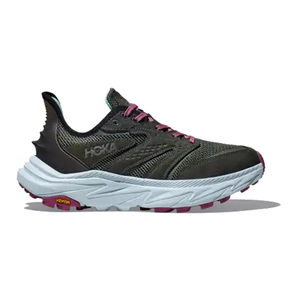 The HOKA ANACAPA 2 FREEDOM OUTER ORBIT/OVERCAST - WOMENS athletic shoe features a dark green and grey design with pink accents and a thick white sole, perfect for running. Its ultra-ventilated upper ensures breathability, while the &quot;Hoka&quot; brand is prominently displayed on the side.