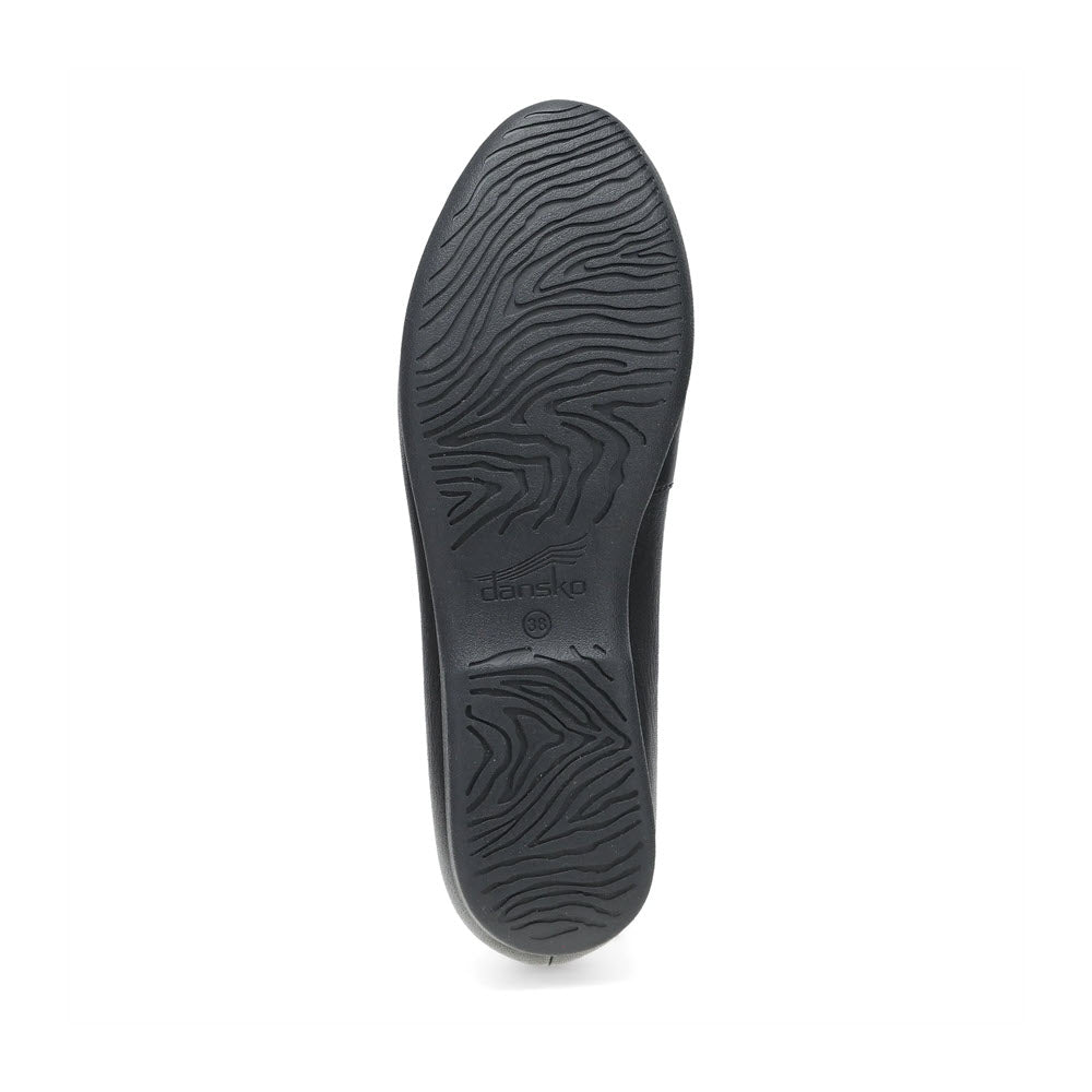 A single black shoe sole with a wavy, textured tread pattern, perfect for casual loafers and offering added support for weekend comfort. The Dansko LORRI BLACK - WOMENS by Dansko fits this description seamlessly.