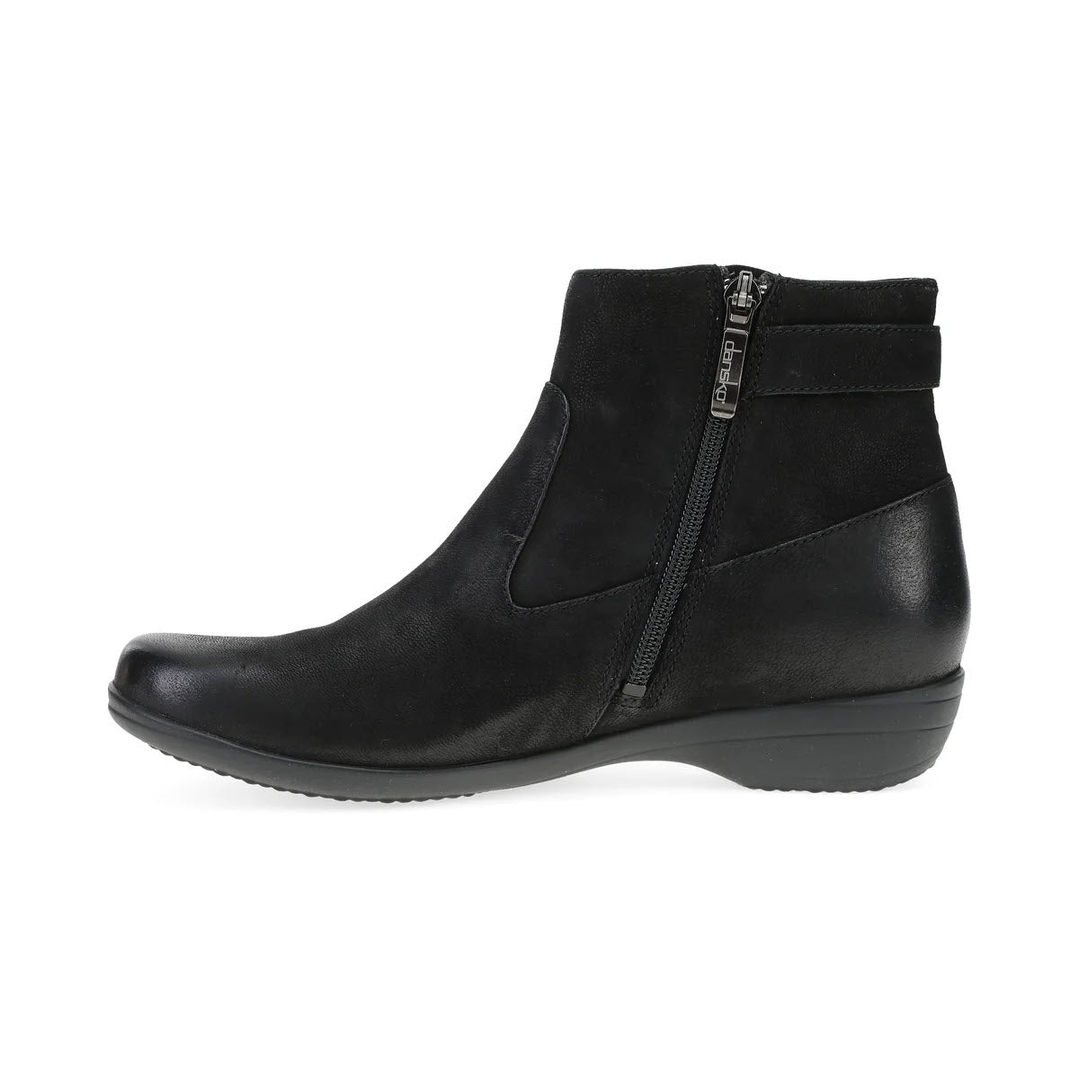 Side view of the Dansko Finnley Black women&#39;s ankle boot, featuring a side zipper and low wedge heel. This black leather boot offers all-day comfort with Dansko Natural Arch® technology, making it perfect for both work and weekend wear.