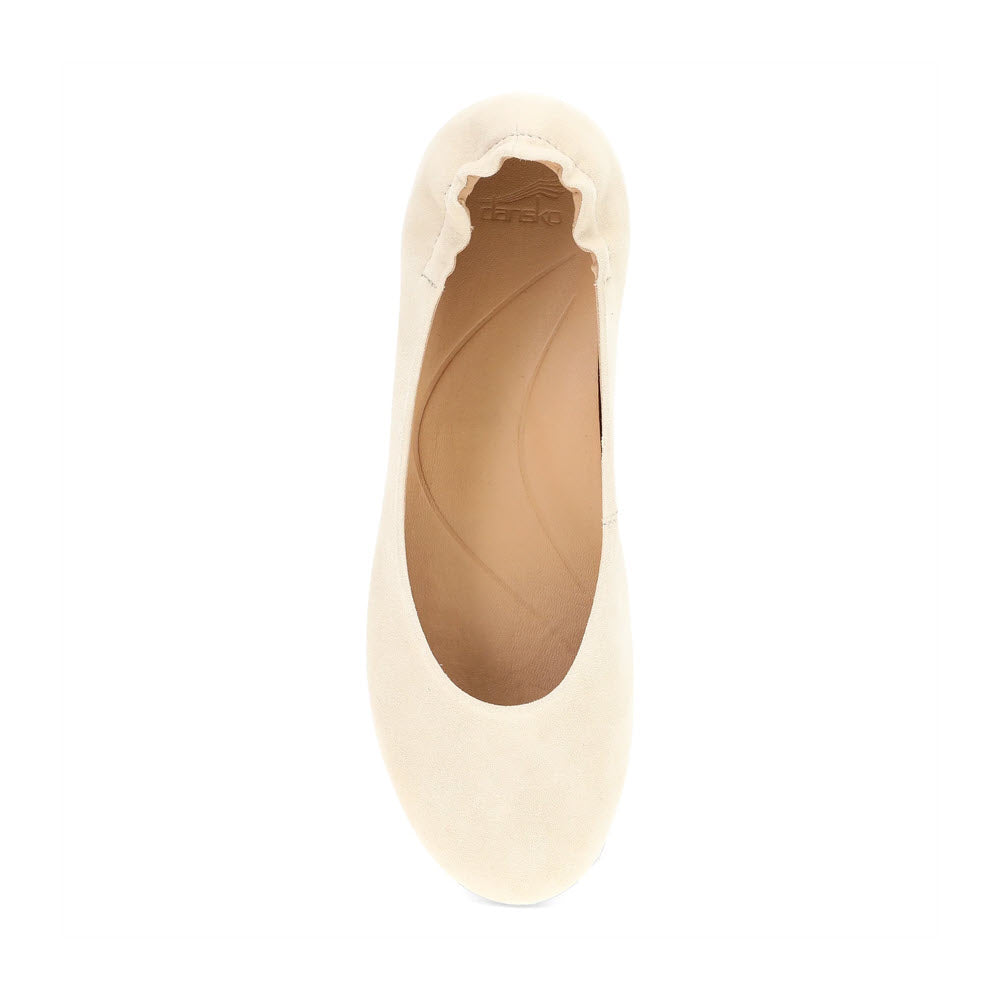 The DANSKO MOLLIE SAND - WOMENS by Dansko offers chic comfort with its beige hue, rounded toe, elasticized opening, and a supportive beige insole.