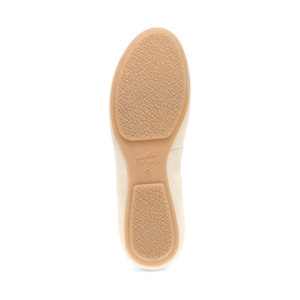 The outsole of the Dansko DANSKO MOLLIE SAND - WOMENS seen from the bottom, featuring a textured surface for grip and a beige color that combines chic comfort effortlessly.