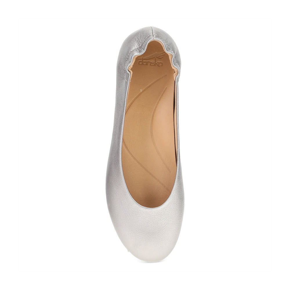 Top view of the chic, comfortable Dansko Mollie Pewter - Womens in silver by Dansko, featuring a scalloped edge at the heel and a beige insole.