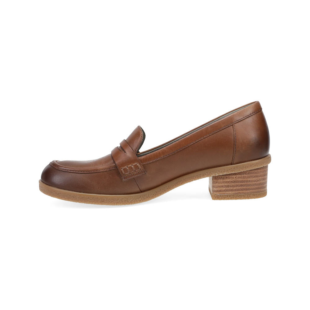 The DANSKO DANICA TAN - WOMENS loafer from Dansko is a single brown leather chunky shoe with a subtle heel, featuring stitching details and a rounded toe.