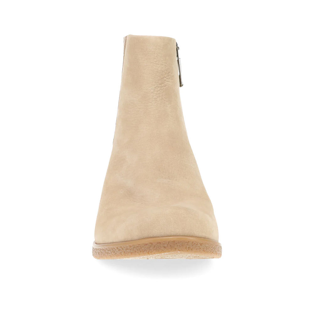 Front view of the Dansko Daisie Sand women&#39;s ankle boot featuring tan suede, a side zipper, a light brown sole, and Dansko support for added comfort.