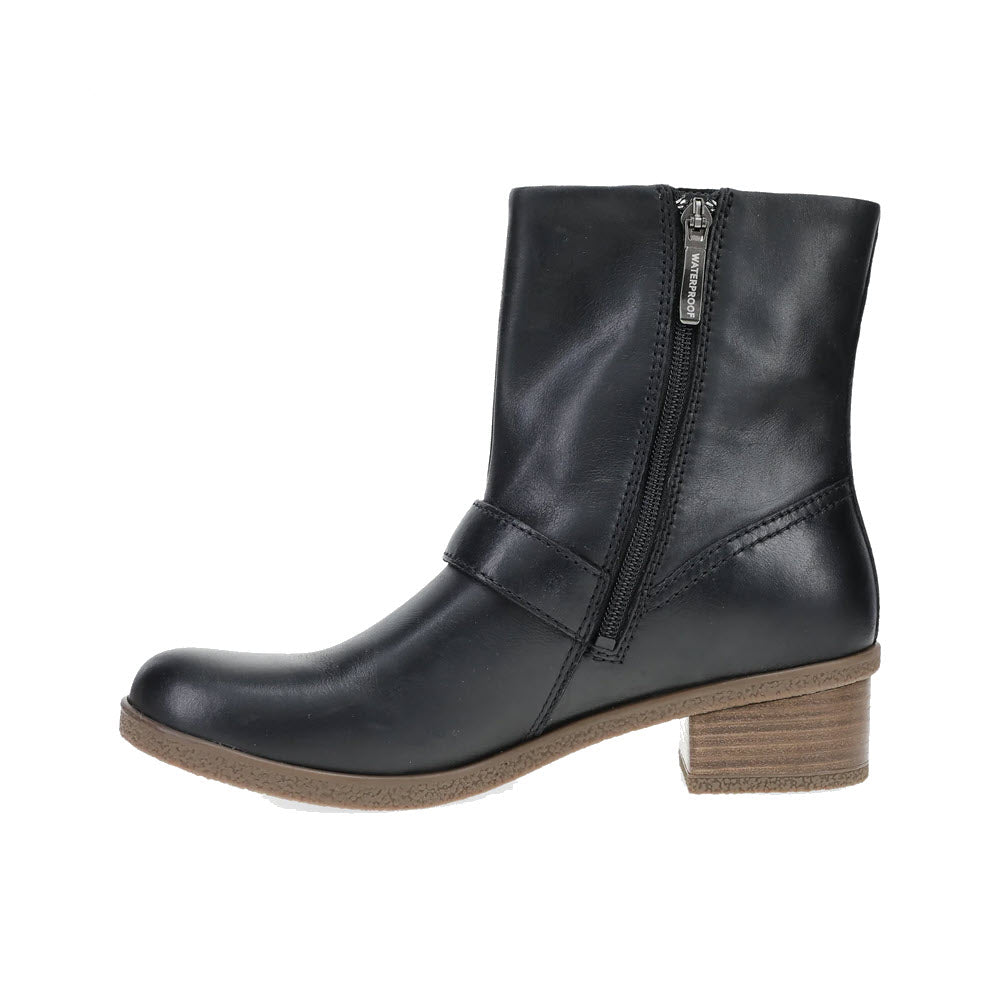 The DANSKO DELPHINE BLACK - WOMENS boot by Dansko is a black leather ankle boot with stylish hardware, featuring a brown low block heel and side zipper.