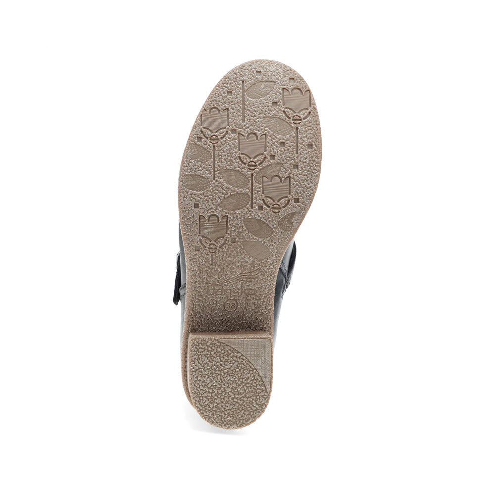 Bottom view of the DANSKO DELPHINE BLACK - WOMENS sandal by Dansko, featuring a patterned sole with flower and leaf designs, accented with stylish hardware.