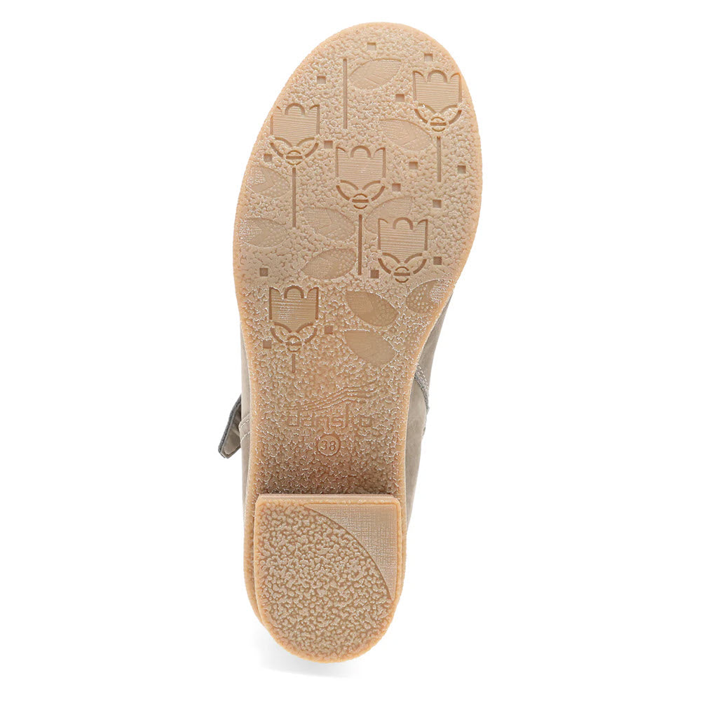 The bottom view of the sole of the Dansko Delphine Stone women&#39;s moto bootie showcases embossed floral patterns and various textures.