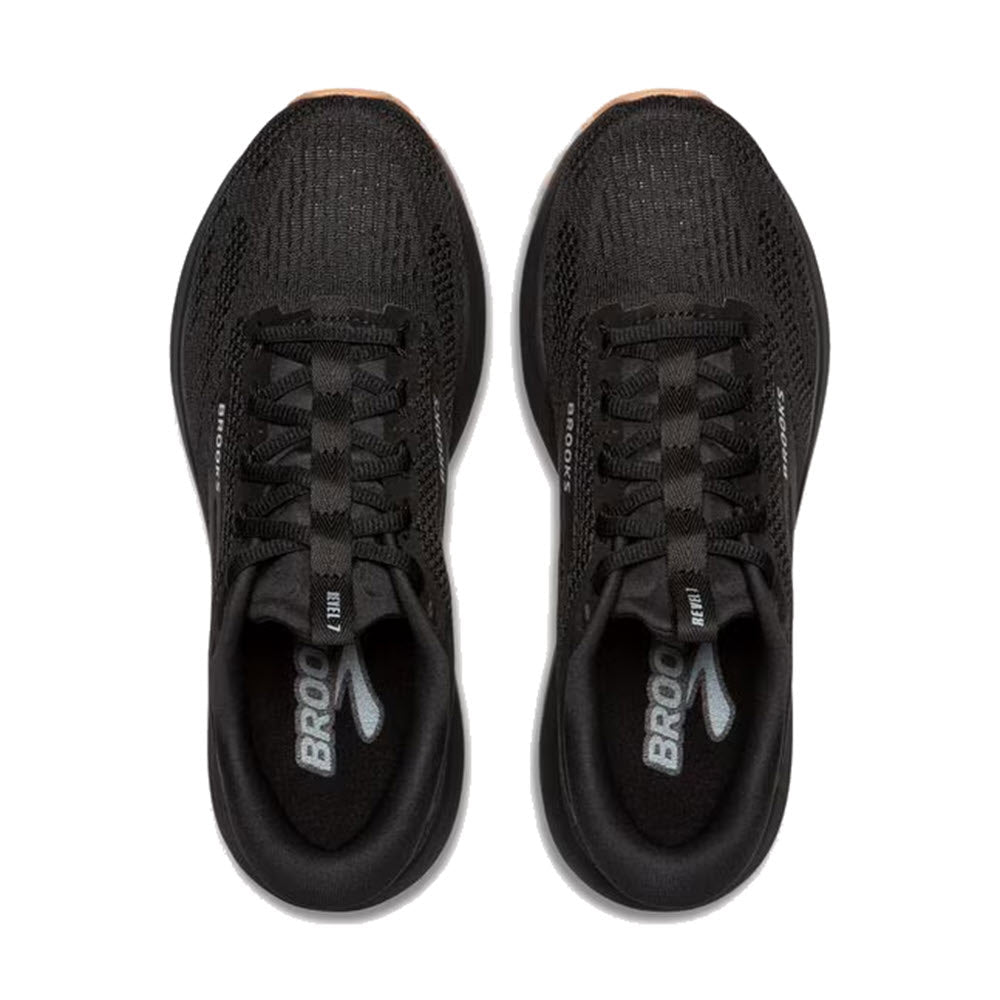 A pair of BROOKS REVEL 7 BLACK/BLACK running shoes for women by Brooks, viewed from above, showcasing laces and mesh material on the upper, featuring adaptable cushioning for a comfortable run.