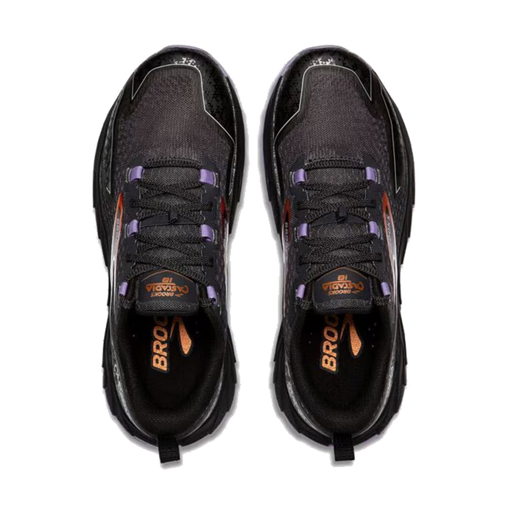 Top view of a pair of Brooks women&#39;s trail-running shoes in ebony, sweet lavender, and copper hues, with the brand name &quot;Brooks&quot; on the insoles. The BROOKS CASCADIA 18 features cushioning for comfort and sticky traction for optimal grip on various terrains.