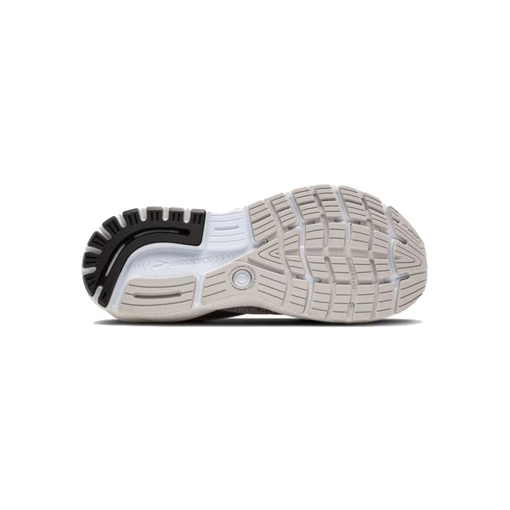 The image shows the sole of the BROOKS GHOST 16 GREY/GARGOYLE/PINK - WOMENS running shoe from Brooks, displaying multiple tread patterns with areas in white, grey, and black. The shoe is designed for a comfortable fit and lightweight cushioning.