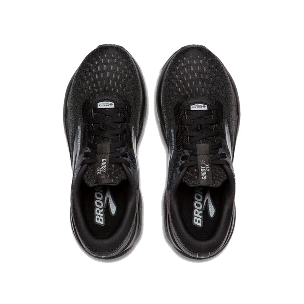 Top view of a pair of Brooks Ghost 16 GTX women&#39;s running shoes in black/black/ebony, featuring white logos and perforated mesh uppers with breathable GORE-TEX.