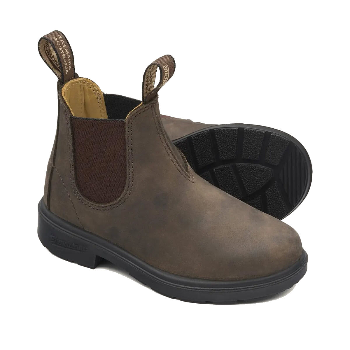 BLUNDSTONE 565 CHELSEA BOOTS RUSTIC BROWN - KIDS by Blundstone are brown, slip-on ankle boots with black rubber soles and pull tabs on the front and back. These boots are modeled after the Blundstone Original boots, offering exceptional durability and excellent shock absorption for all-day comfort.