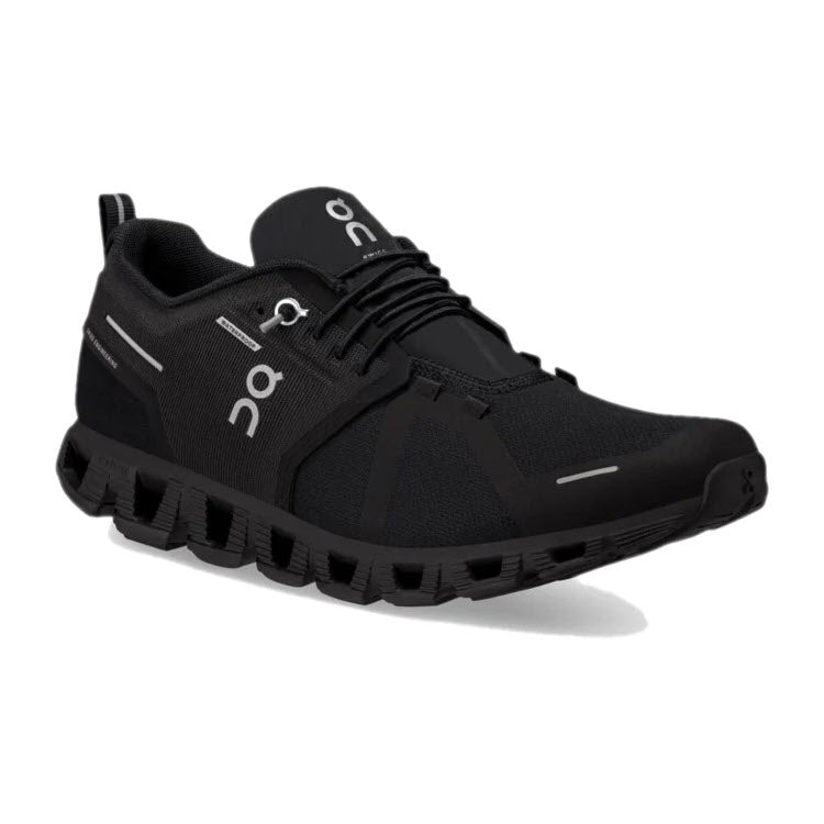 A single women&#39;s ON CLOUD 5 WATERPROOF ALL BLACK athletic shoe is shown, featuring a mesh upper, CloudTec cushioning midsole with a segmented outsole, and &quot;On Running&quot; branding on the side and tongue.