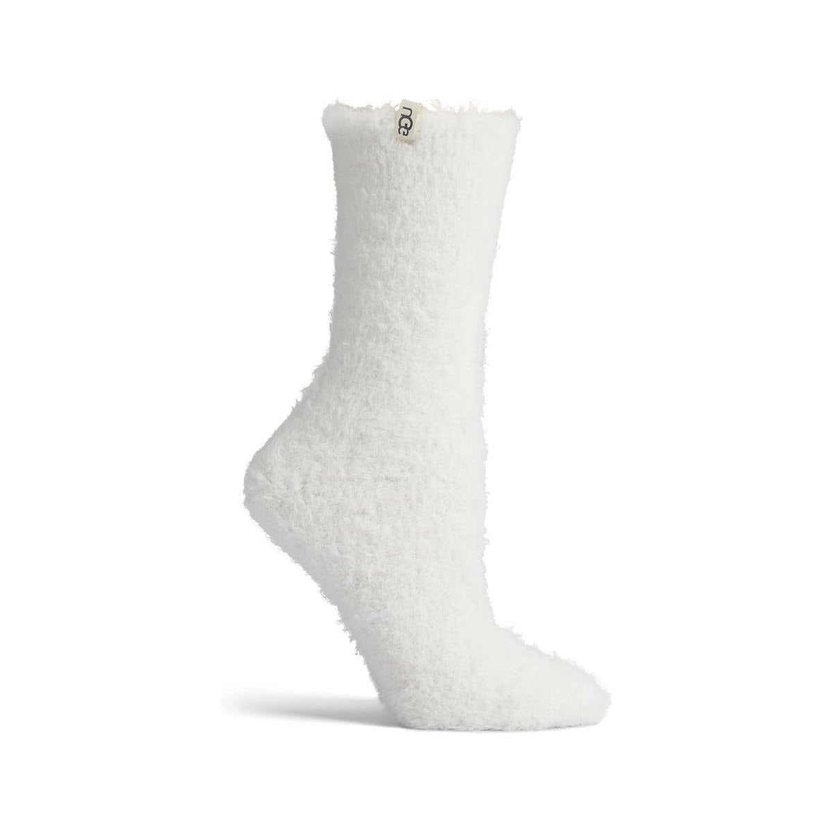 A solitary UGG Teddie Cozy Crew Sock in cream, featuring a subtle brand tag on the top, evokes a sense of comfort similar to the classic UGG style and is showcased against a simple white backdrop.