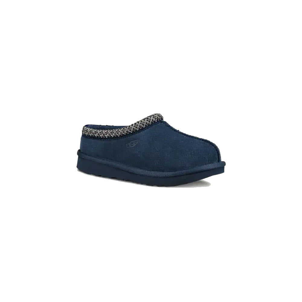 UGG TASMAN II NEW NAVY - KIDS by Ugg: A navy blue slip-on shoe featuring a stylish patterned trim and a thick sole, ideal for use as both an indoor slipper and a versatile outdoor shoe.