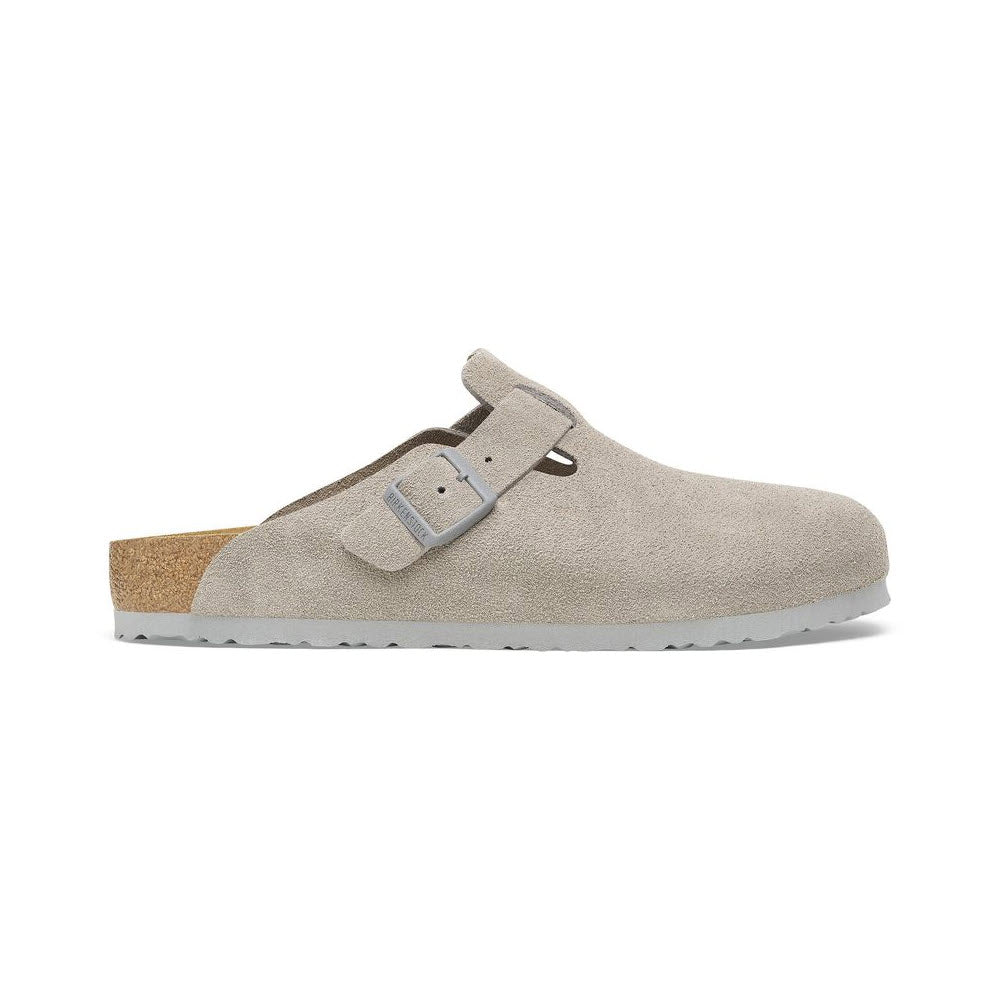 The Birkenstock Boston Stone Coin for women is a single beige clog made from suede, showcasing a grey buckle strap and a cork sole with a contoured footbed.