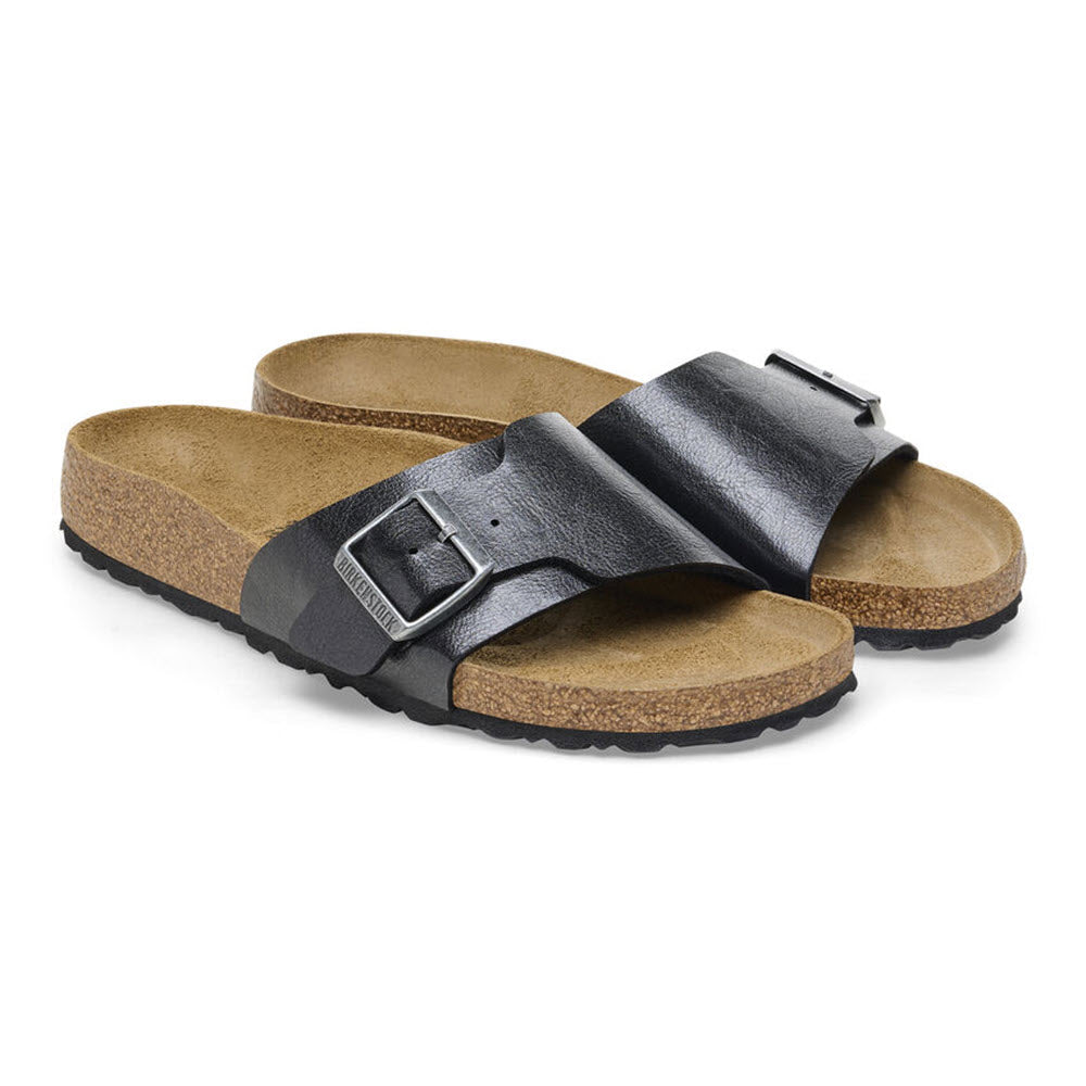 A pair of black open-toe BIRKENSTOCK CATALINA GRACEFUL LICORICE - WOMENS sandals featuring brown cork-like soles and black adjustable straps with buckles, embodying the classic Birkenstock style.