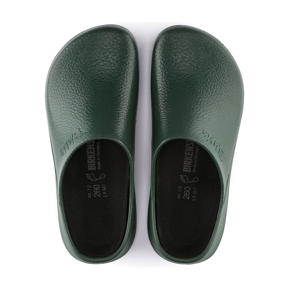 A pair of **Birkenstock BIRKENSTOCK SUPER BIRKI GREEN - WOMENS** clog slip-on shoes with anatomic support and black insoles, seen from above.