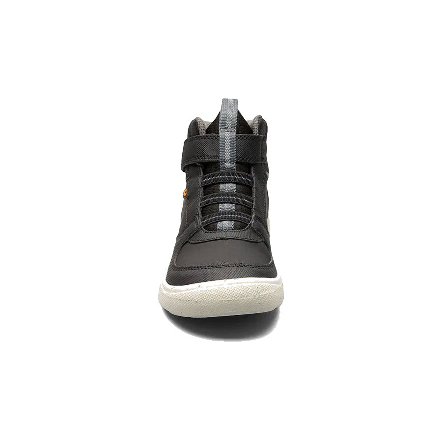 Front view of a single BOGS SKYLINE HIGH TOP BLACK - KIDS shoe by Bogs, featuring a black design with a white sole, black laces, and a water-resistant Velcro strap.