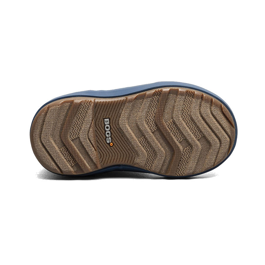 The image displays the bottom view of a single shoe from the BOGS CLASSIC II VINTAGE FLORAL - KIDS collection by Bogs, showcasing a zigzag tread pattern on a brown rubber sole with &quot;BOGS&quot; imprinted in the center. This design enhances traction and promotes natural foot movement.