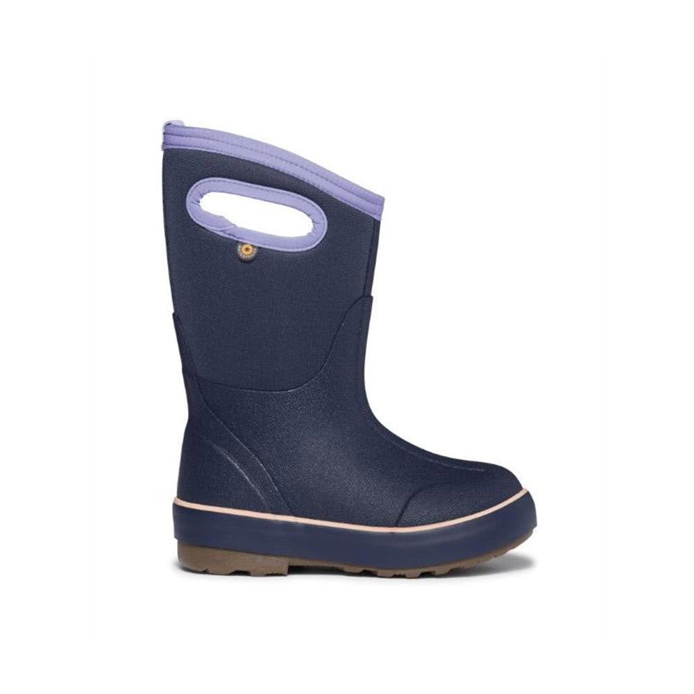 A single Bogs rain boot, named &quot;BOGS CLASSIC II SOLID INDIGO - KIDS,&quot; featuring a dark blue color with a purple trim and integrated handles, designed for better traction and natural foot movement.