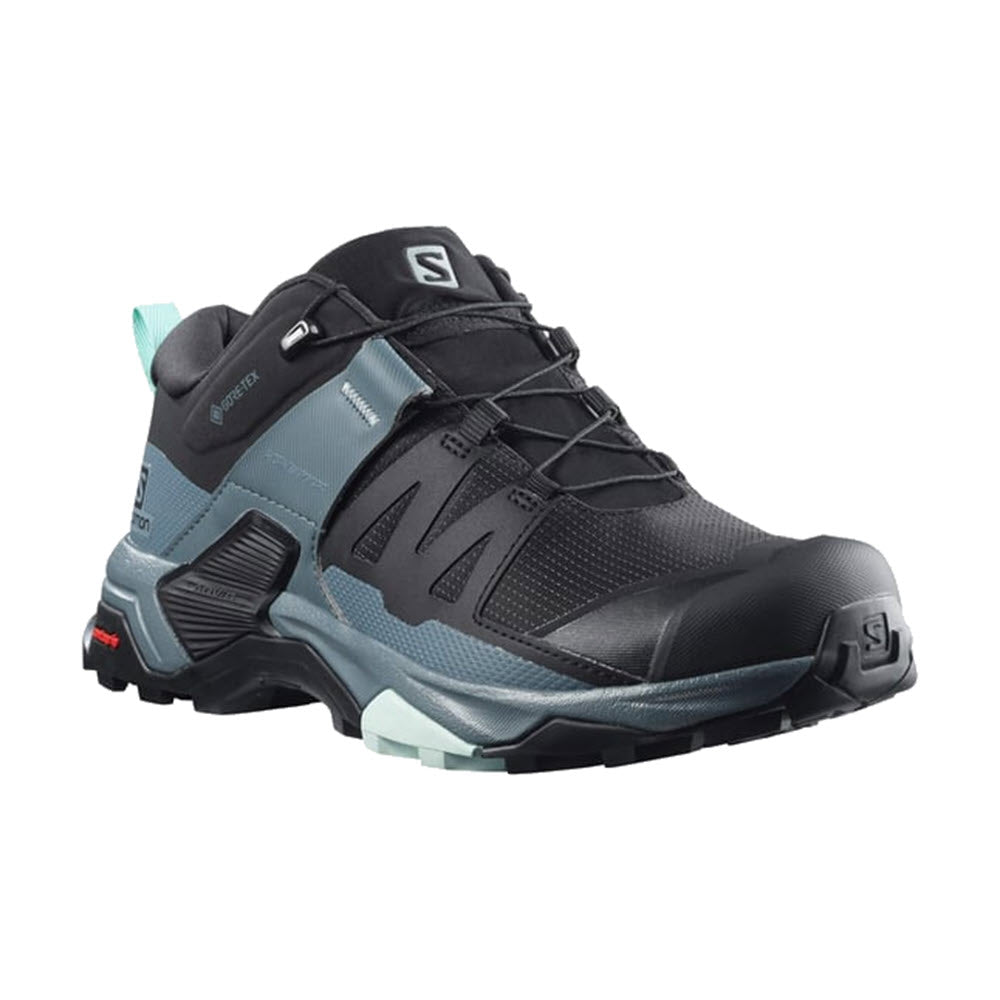 The Salomon X Ultra 4 in Black/Stormy Weather/Opal Blue for women is a hiking shoe designed for outdoor activities, featuring a rugged Contragrip MA sole and SensiFit laces, along with a logo on the tongue and heel.