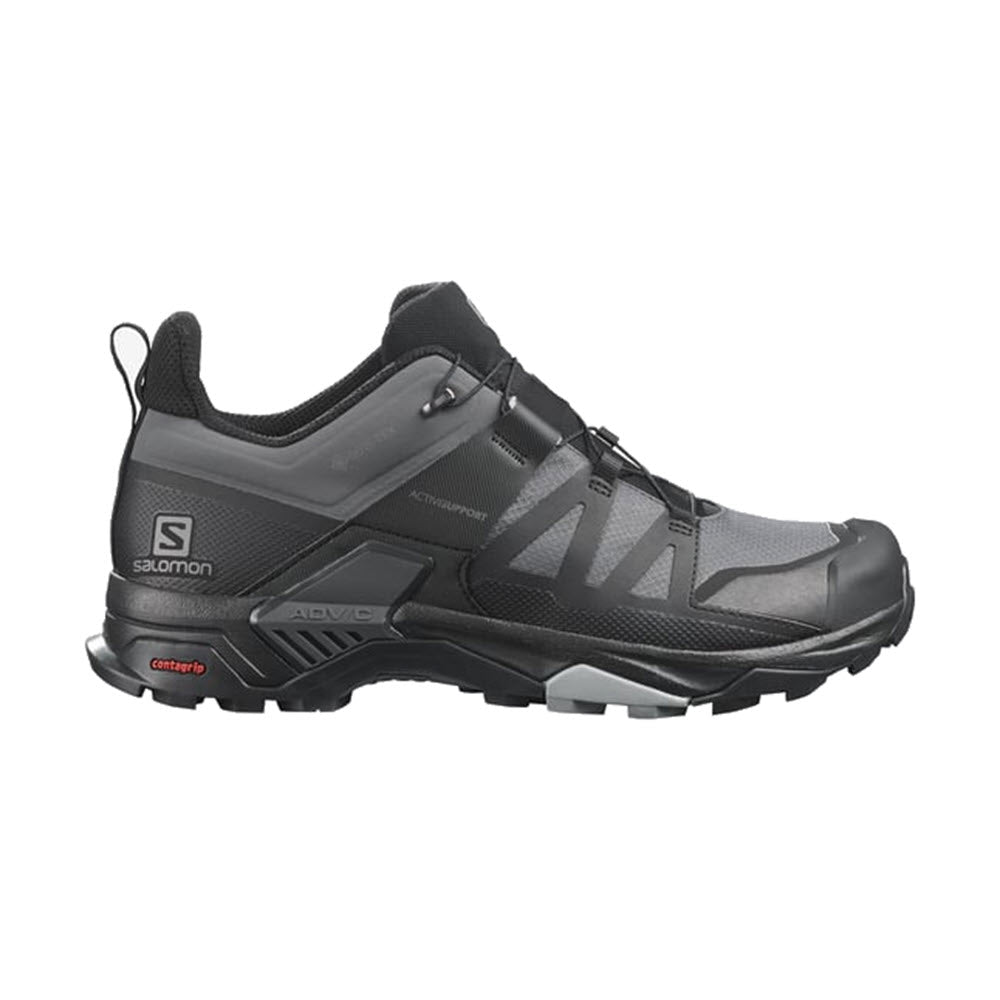 The SALOMON X ULTRA 4 MAGNET/BLACK/MONUMENT for men is a black and grey hiking shoe that prominently features the Salomon brand name on the side. It comes equipped with a rugged Contagrip® sole system for excellent traction and durability, while the Sensifit™ upper technology ensures a secure fit.