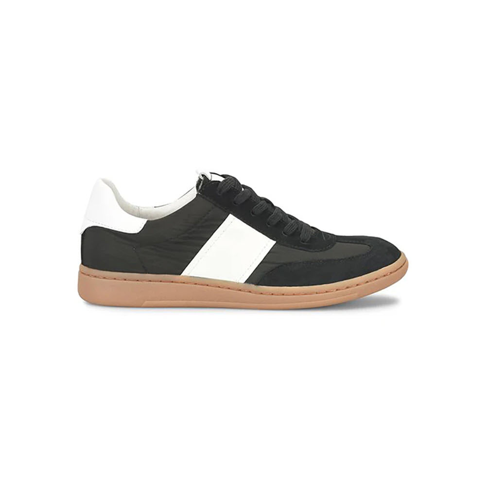 A black and white sneaker with a tan sole, perfect for a modern-cool work look. The SOFFT RUBY BLACK - WOMENS by Sofft features black laces, a white accent on the heel, and a white side stripe. The outer toe and heel areas appear to be made of suede.