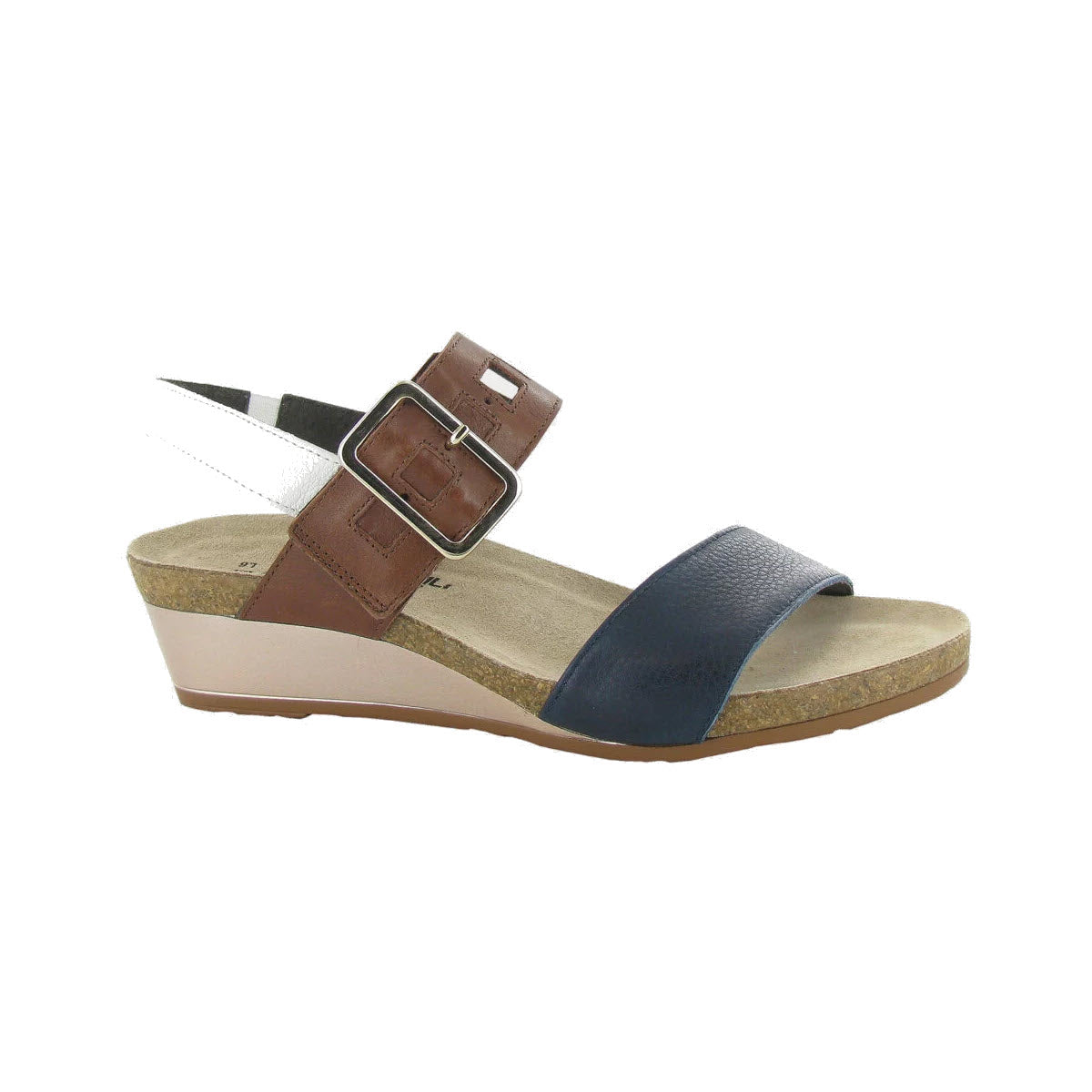 A Naot NAOT DYNASTY INK CHESTNUT MULTI - WOMENS with a brown and navy blue strap, adjustable buckle on the ankle strap, a tan cork footbed for added comfort, and a cream-colored sole.