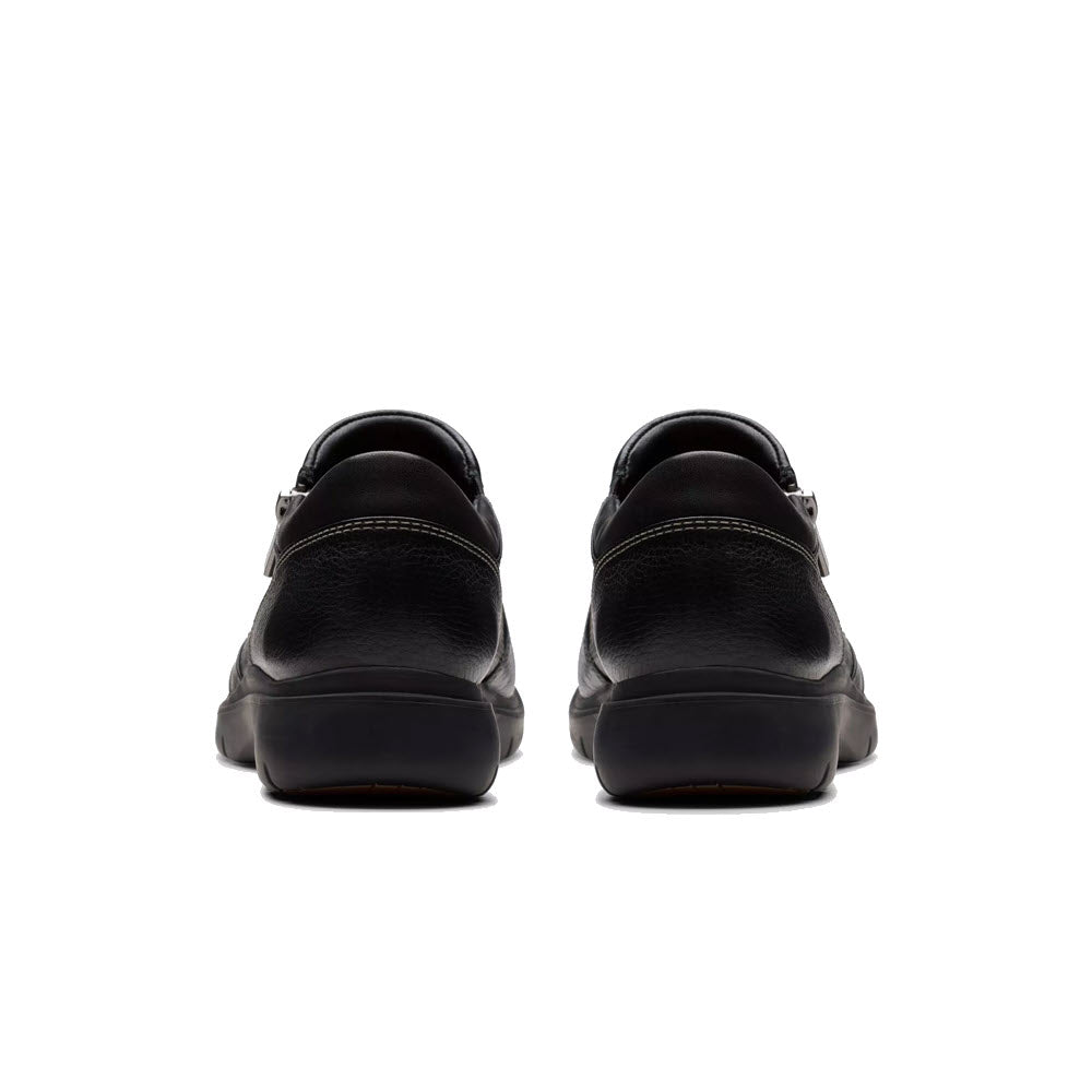 Back view of the Clarks Certina Pure Black women&#39;s sneakers, skillfully crafted from premium leather for exceptional comfort, set against a pristine white background.