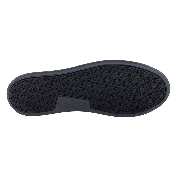 Image of the black sole of a VOLCOM COMPOSITE TOE CHILL SLIP ON WORK SHOE ESD BLACK - MENS with a diamond-shaped textured pattern and the brand name &quot;Volcom&quot; embossed in the center.