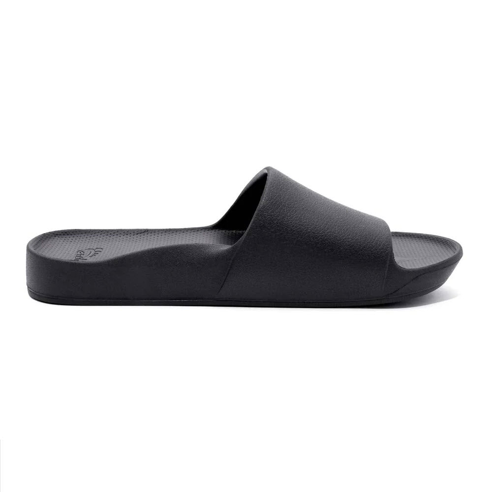 A single black ARCHIES SLIDES sandal with a textured footbed and an open toe design, featuring durable orthotic support, shown against a white background by Archies.