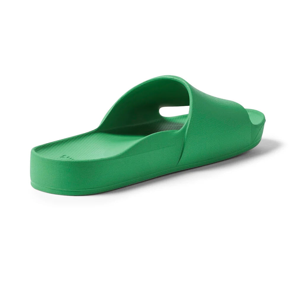 A single green slide sandal with a thick sole and an open toe, viewed from the side, perfect for those seeking ARCHIES SLIDES with orthotic support ideal for alleviating plantar fasciitis.