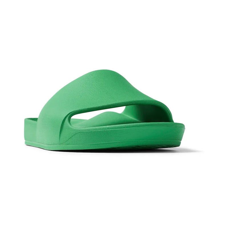 A green foam Archies ARCHIES SLIDES with a single wide strap over the top and an open toe design, photographed from a low angle, offering orthotic support ideal for those suffering from Plantar Fasciitis.