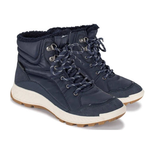 A pair of Baretraps Maine Midnight navy blue winter boots with White soles, black laces, and a waterproof membrane.